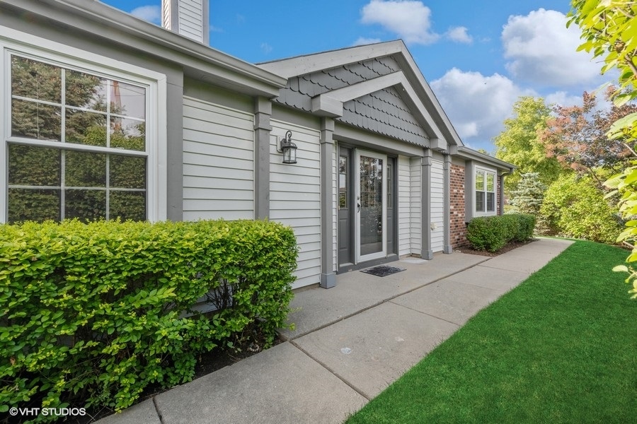 393 Bentley Place Buffalo Grove, IL 60089 - Photo 2 of 16 a front view of a house with garden