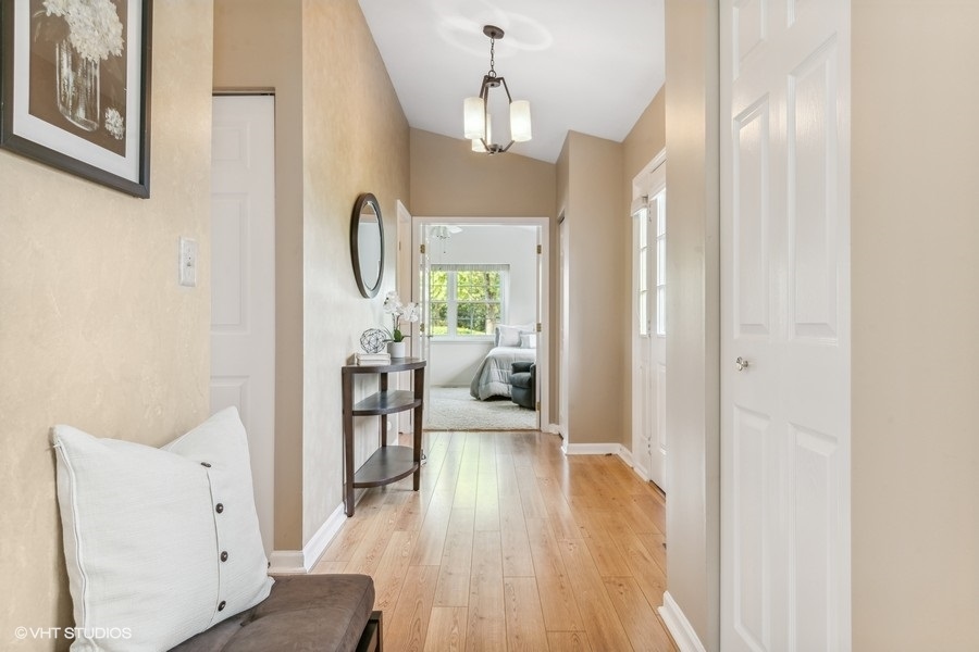393 Bentley Place Buffalo Grove, IL 60089 - Photo 3 of 16 a view of a hallway with wooden floor windows and livingroom