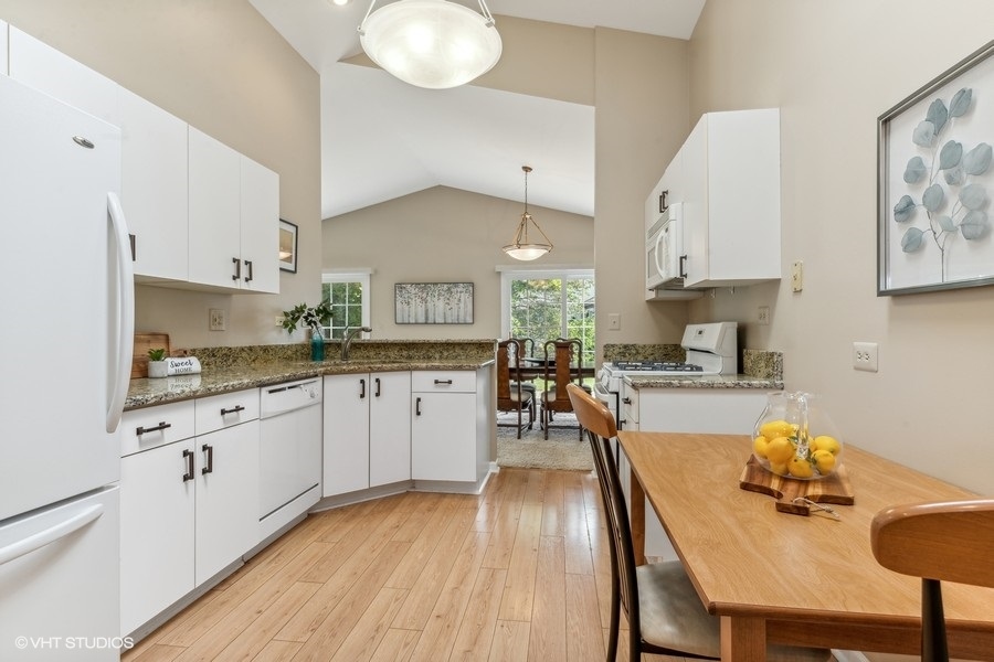 393 Bentley Place Buffalo Grove, IL 60089 - Photo 8 of 16 a kitchen with a sink white cabinets and stainless steel appliances