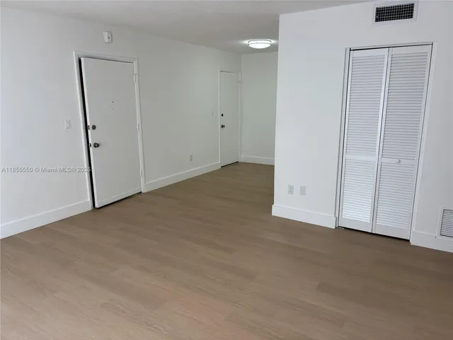 an empty room with closet area