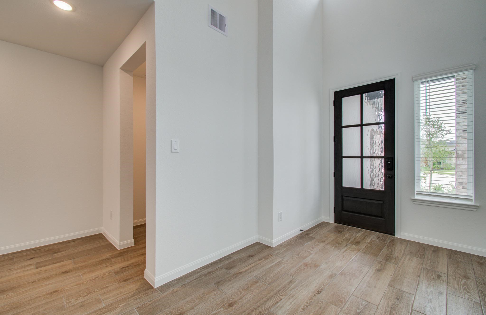 7231 Yarrow Blossom Court Katy, TX 77493 - Photo 13 of 49 an empty room with wooden floor and windows