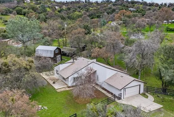 an aerial view of a house with a yard
