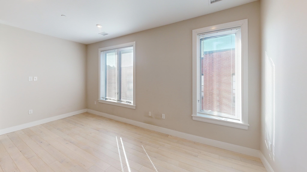 197 Green Street, Unit 402 Boston, MA 02130 - Photo 2 of 6 a view of an empty room with a window