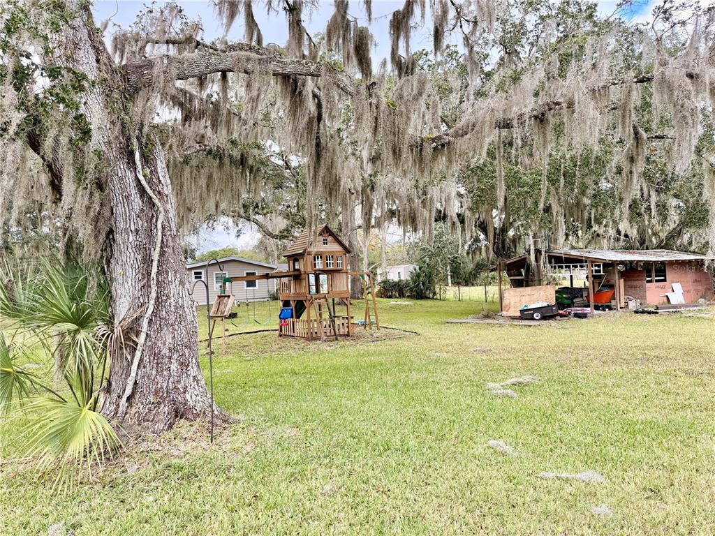 685 Eagle Watch Road Oak Hill, FL 32759 - Photo 14 of 21 a view of a park with swings and slides