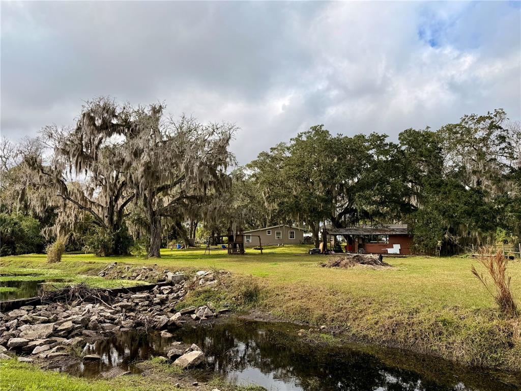 685 Eagle Watch Road Oak Hill, FL 32759 - Photo 15 of 21 a view of a park with large trees
