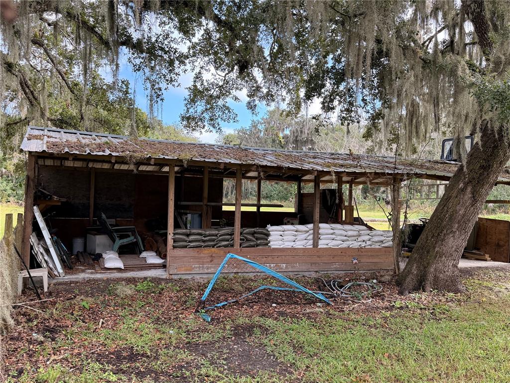 685 Eagle Watch Road Oak Hill, FL 32759 - Photo 17 of 21 a view of a house with backyard porch and sitting area