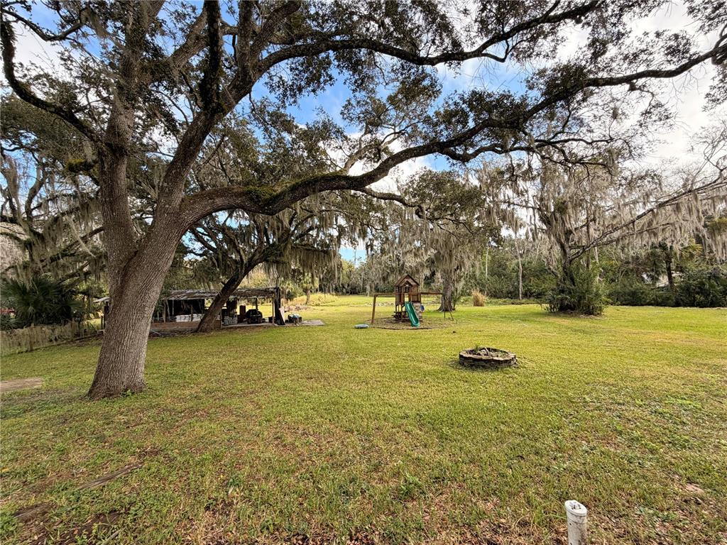 685 Eagle Watch Road Oak Hill, FL 32759 - Photo 20 of 21 a view of swimming pool with trees and outdoor space
