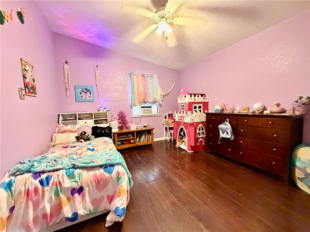 685 Eagle Watch Road Oak Hill, FL 32759 - Photo 5 of 21 a bedroom with a bed and a chandelier