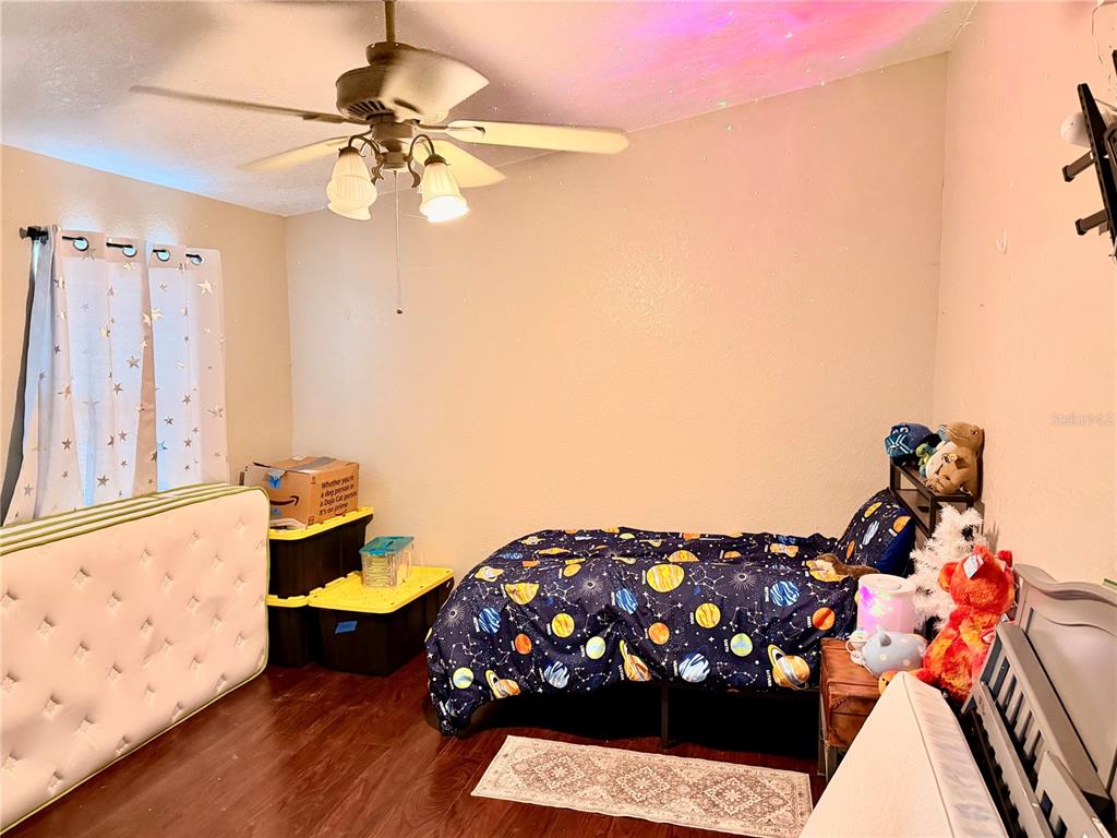 685 Eagle Watch Road Oak Hill, FL 32759 - Photo 7 of 21 a living room with furniture and a chandelier