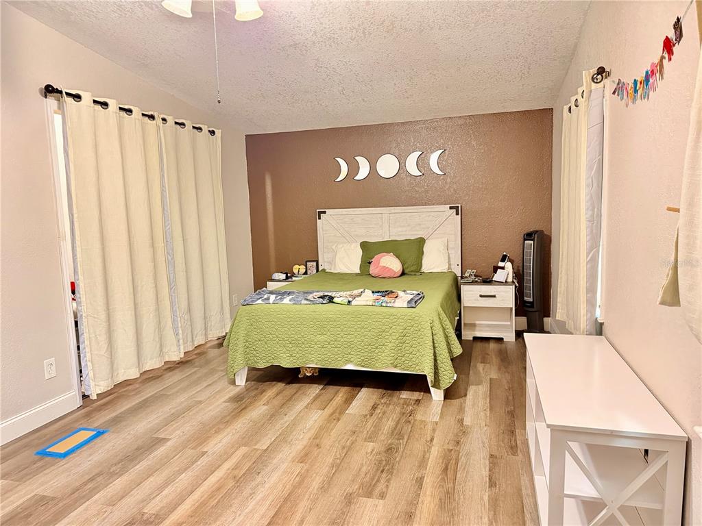 685 Eagle Watch Road Oak Hill, FL 32759 - Photo 8 of 21 a bedroom with a bed and a large window