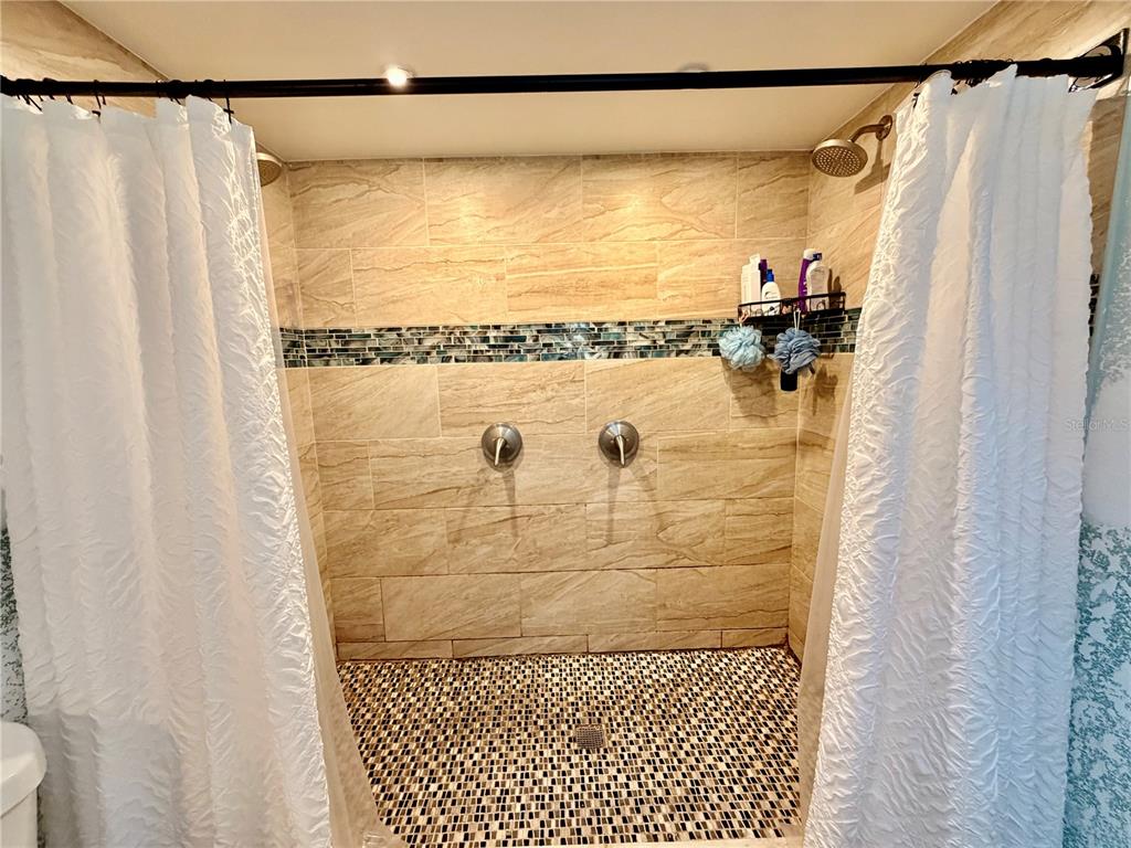 685 Eagle Watch Road Oak Hill, FL 32759 - Photo 9 of 21 a bathroom with a shower and a tub