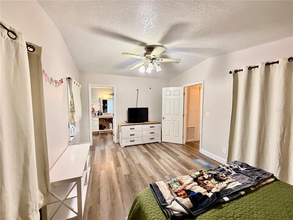 685 Eagle Watch Road Oak Hill, FL 32759 - Photo 10 of 21 a living room with furniture and a flat screen tv