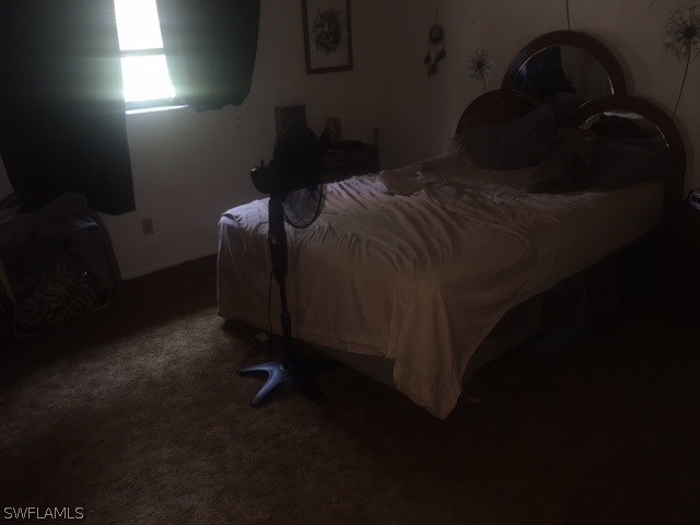 7460 Garry Road Fort Myers, FL 33967 - Photo 19 of 21 a bed sitting in a bedroom next to a window