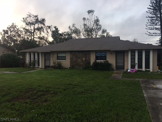 7460 Garry Road Fort Myers, FL 33967 - Photo 4 of 21 a front view of a house with a garden