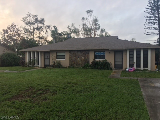 7460 Garry Road Fort Myers, FL 33967 - Photo 5 of 21 a front view of a house with a garden and yard