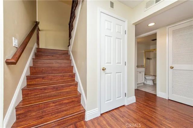 a view of a hallway with wooden floor and entryway