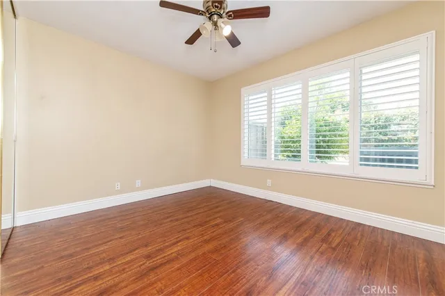 a view of a room with wooden floor and windows