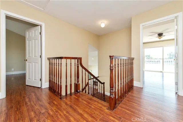 a view of a room with wooden floor and windows
