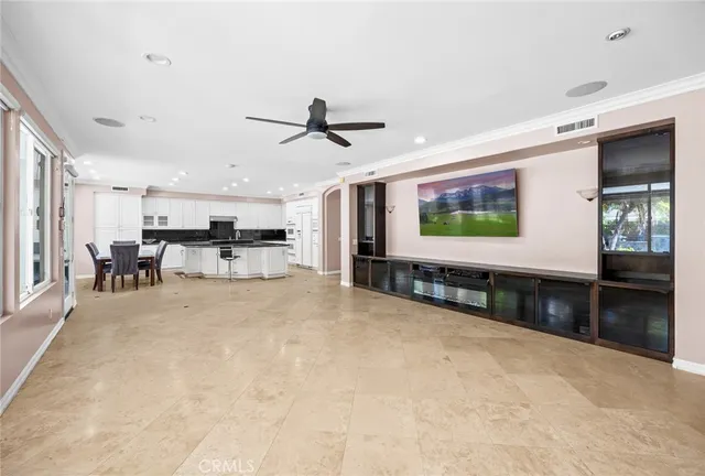 a view of a livingroom with furniture a ceiling fan and window