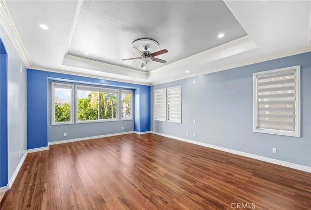 a large white bathroom with a large tub sink shower and mirror