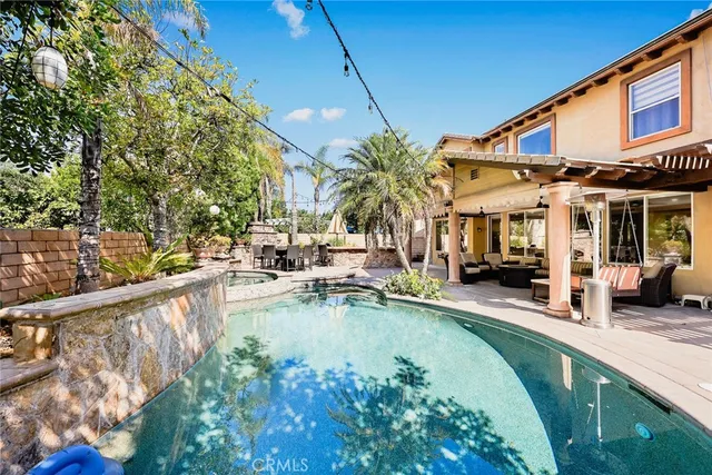 a front view of a house with swimming pool and porch