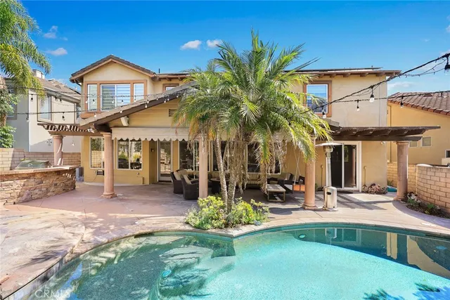 a patio with a table and chairs and potted plants