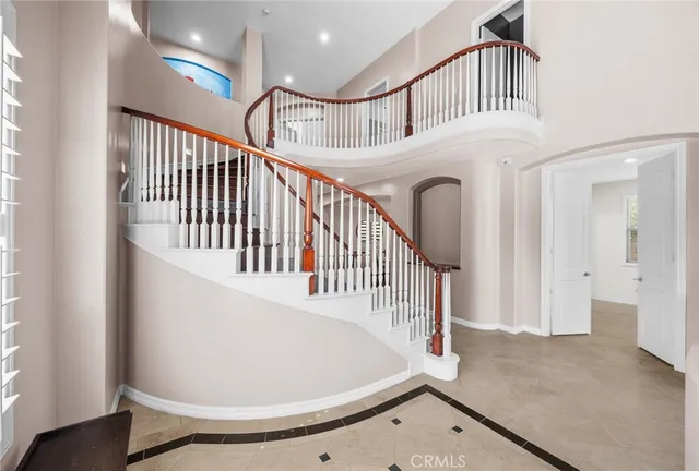 a view of staircase with white walls and a window