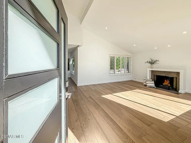 a view of an empty room and fire place