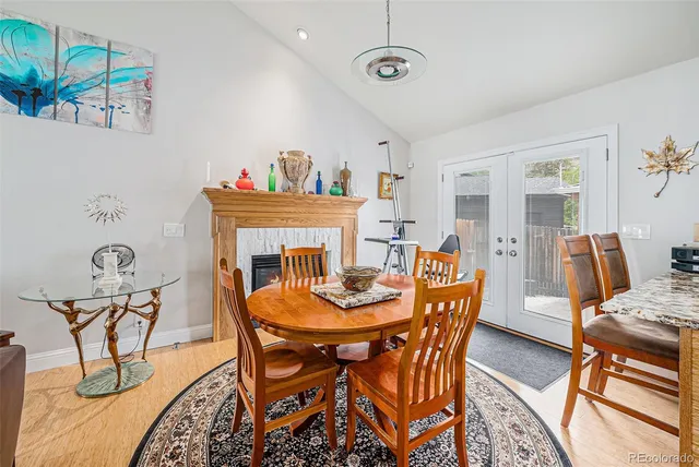a dining room with furniture a fireplace and chandelier