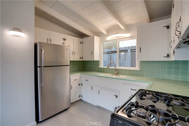 a kitchen with a refrigerator and a sink