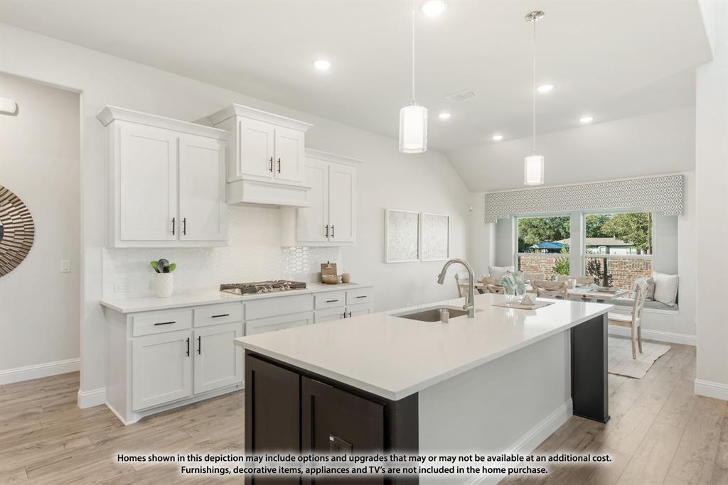 12709 Cactus Court Godley, TX 76044 - Photo 15 of 40 a kitchen with a sink a stove a refrigerator and white cabinets with wooden floor