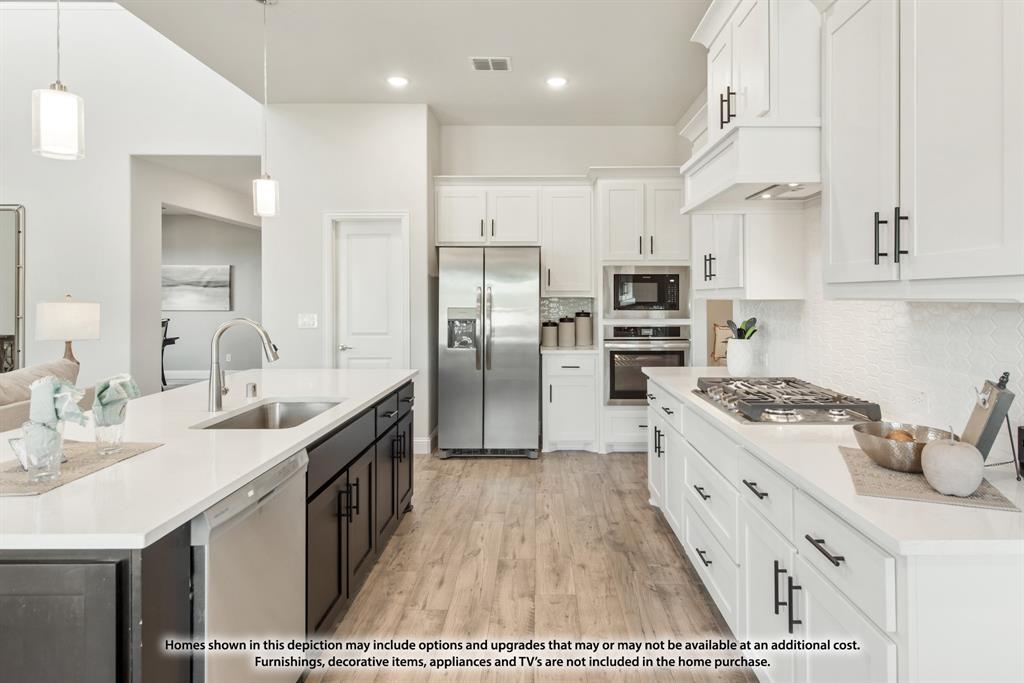 12709 Cactus Court Godley, TX 76044 - Photo 18 of 40 a kitchen with stainless steel appliances kitchen island granite countertop a sink and cabinets