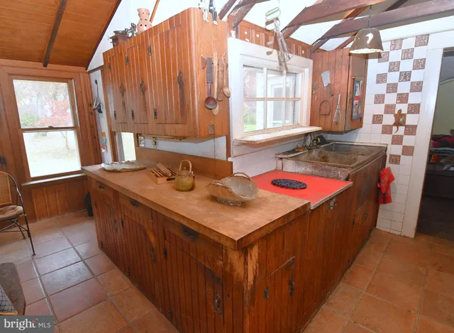 a bathroom with a sink vanity granite and a mirror