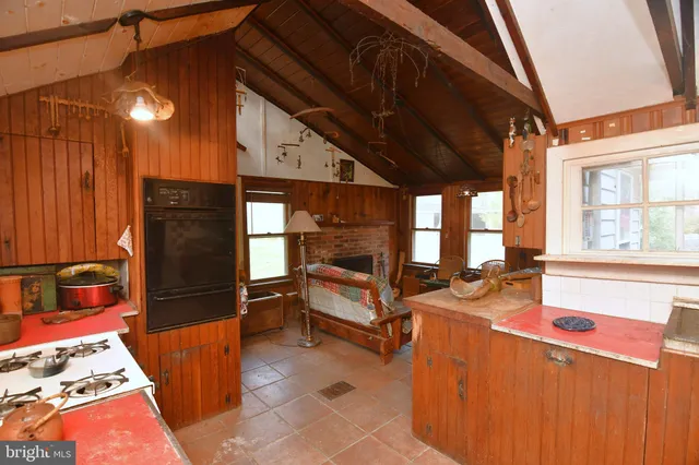 a living room with furniture a window and stainless steel appliances