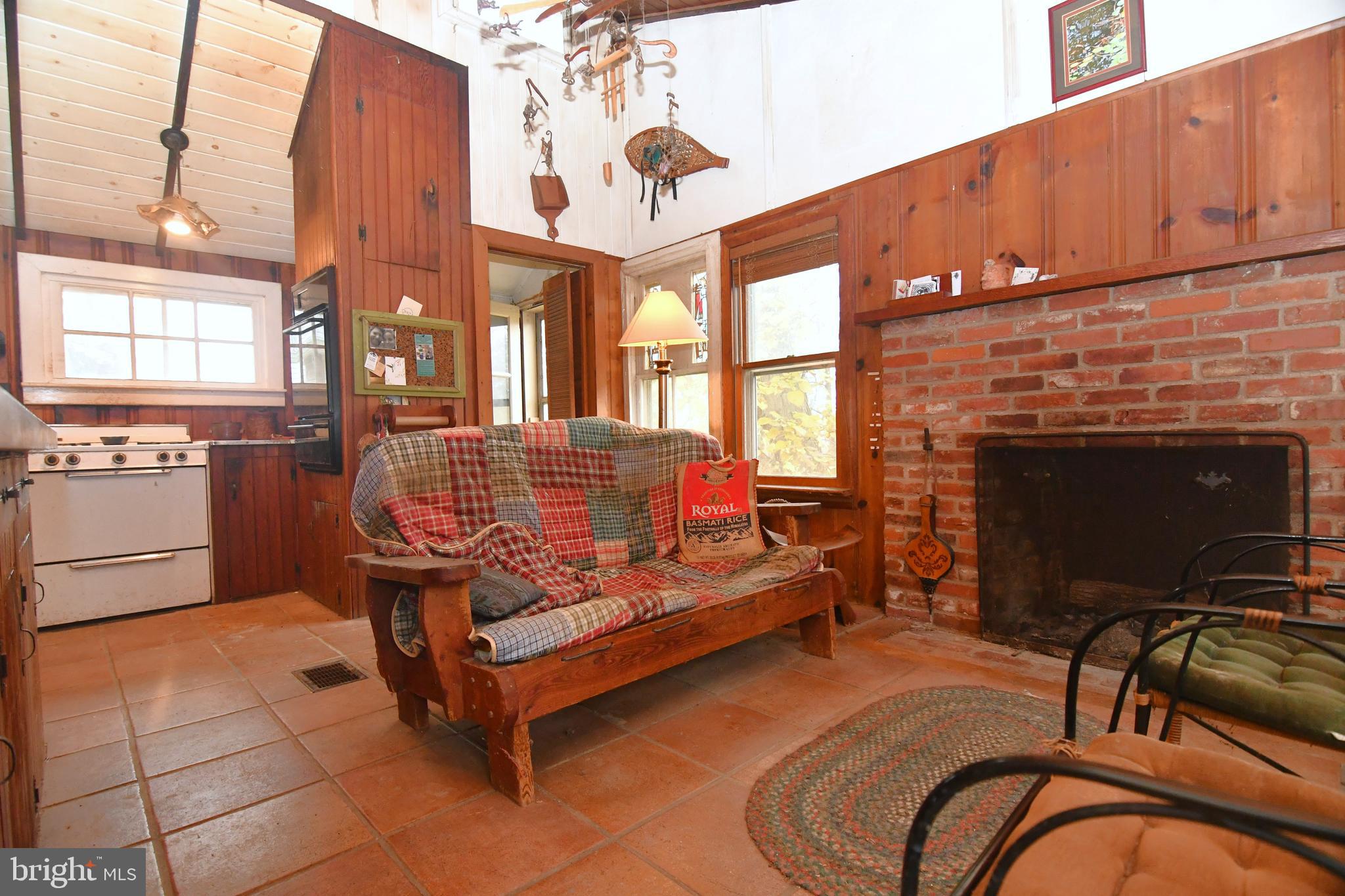 3923 Ferry Road Doylestown, PA 18902 - Photo 17 of 27 a living room with furniture a fireplace and a flat screen tv
