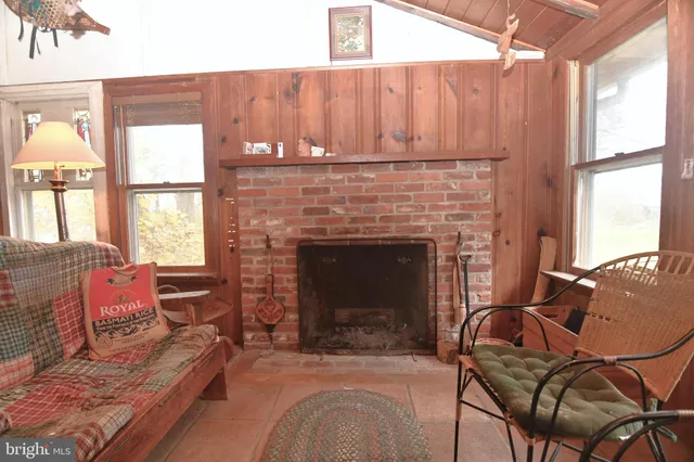 a living room with furniture a fireplace and a table
