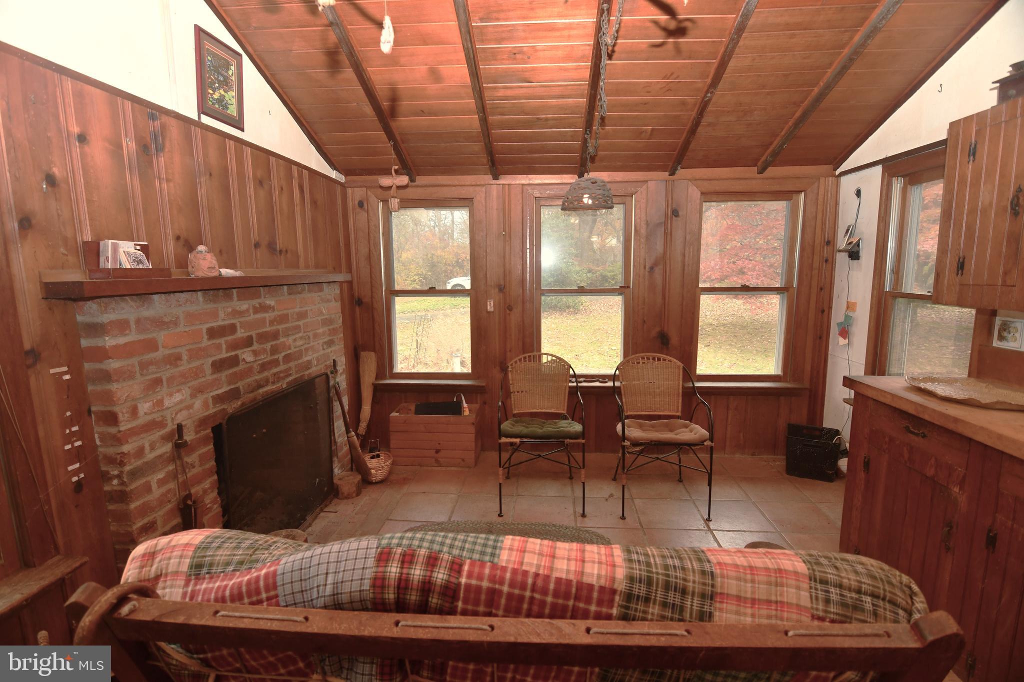3923 Ferry Road Doylestown, PA 18902 - Photo 19 of 27 a living room with furniture a fireplace and a table