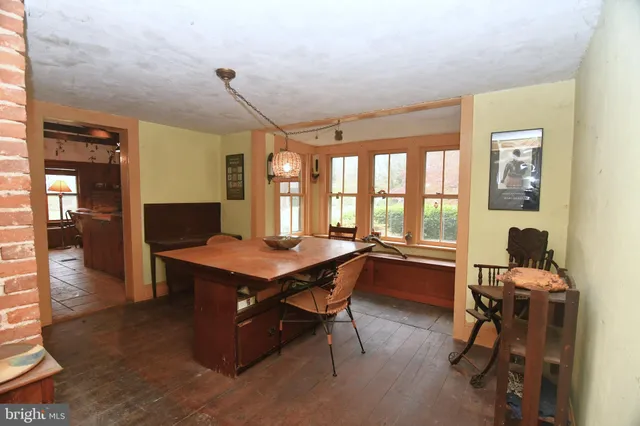 a room with a large window table and chairs