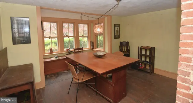 a view of a dining room with furniture and window