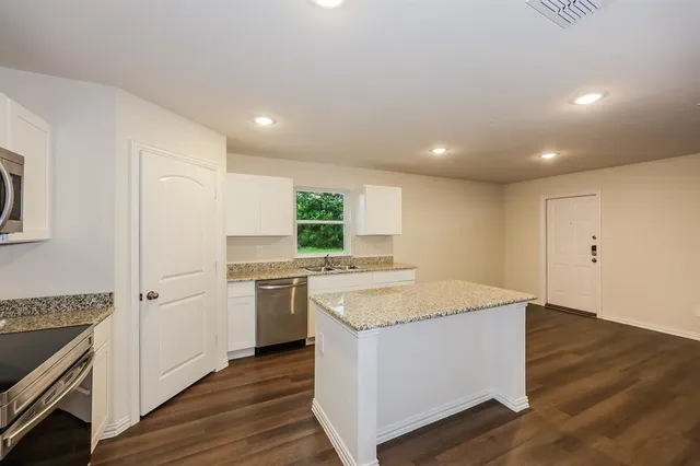 a kitchen with a stove a sink and a refrigerator