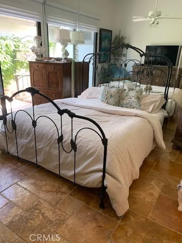 a bedroom with a bed and large mirror