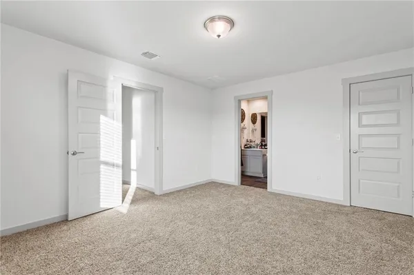 an empty room with closet and windows