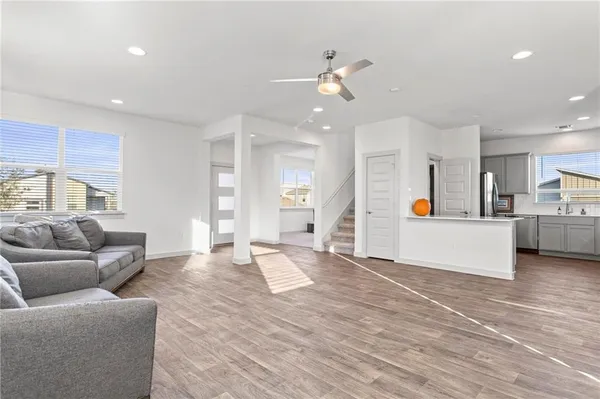 a living room with furniture and kitchen view
