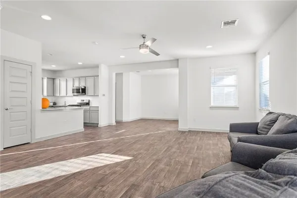 a living room with furniture and kitchen view