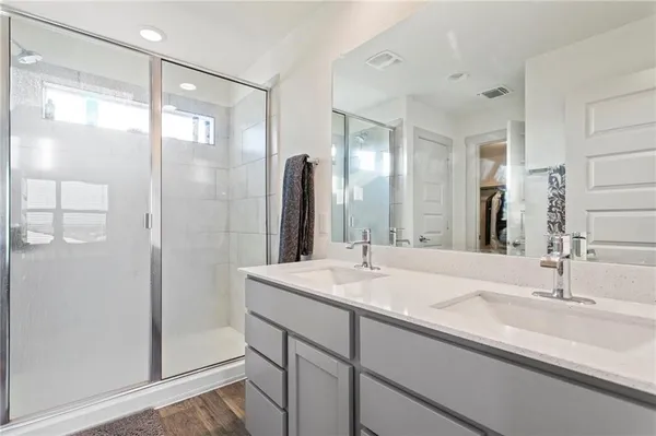 a bathroom with a shower sink and mirror
