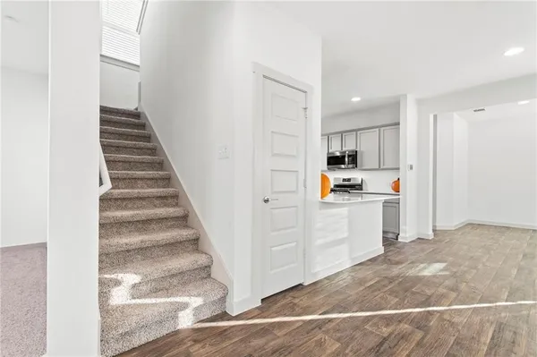 a view of a kitchen with white cabinets and white appliances