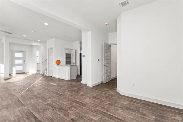 a view of a livingroom with wooden floor and window