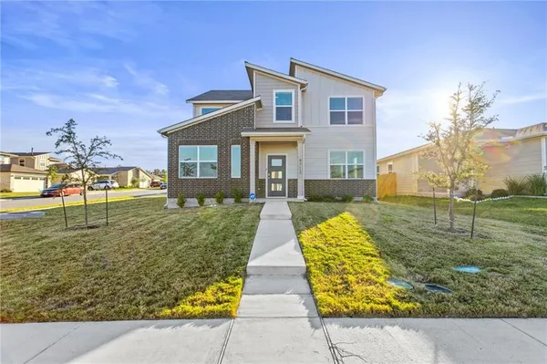 a front view of house with yard and green space