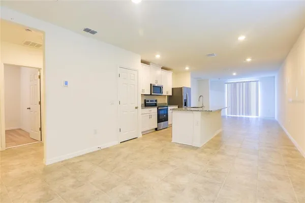 a view of kitchen and kitchen with stainless steel appliances