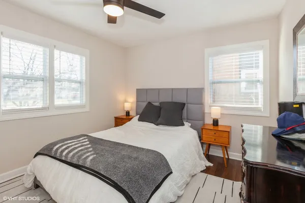 a bedroom with a bed and wooden floor